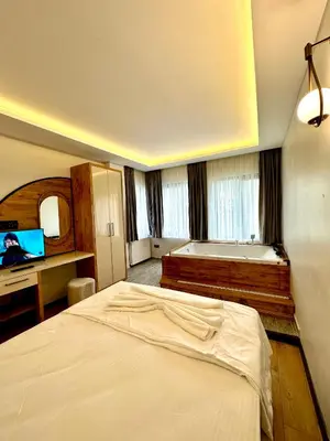 a bedroom with a bed and a tub in it at Newalla Hotel Old City in Istanbul