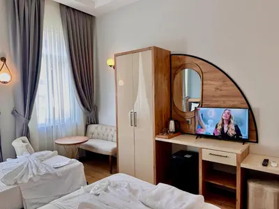 a hotel room with a bed and a mirror at Newalla Hotel Old City in Istanbul