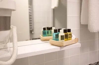 a bathroom with a shelf with soap and a mirror at Joy Taksim in Istanbul