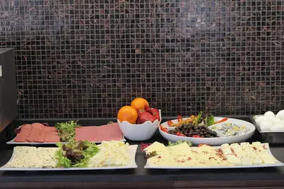a table topped with plates of food and bowls of fruit at Şişli Luxury K Suites Hotel in Istanbul