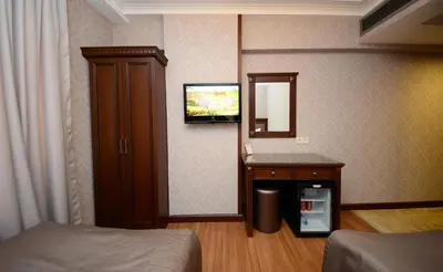 a room with a bed and a mirror and a tv at Grand Bazaar Hotel in Istanbul