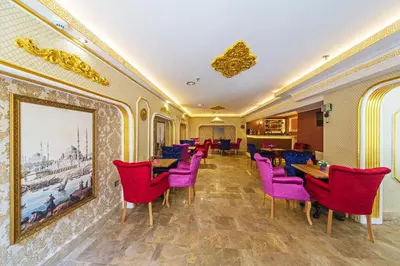 a restaurant with purple chairs and tables and a painting at Lausos Palace Hotel Şişli in Istanbul