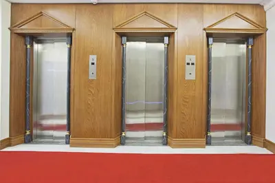 a row of elevators with glass doors in a building at Lausos Palace Hotel Şişli in Istanbul
