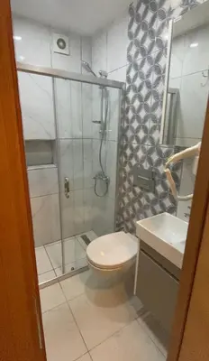 a bathroom with a shower and a toilet and a sink at Riverland Suites Apart Hotel in Istanbul