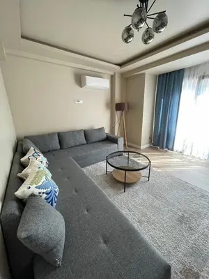 a living room with a couch and a glass table at Myfair apartment in Istanbul