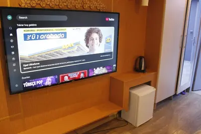 a flat screen tv sitting on top of a wooden wall at Ada Life Hotel in Istanbul