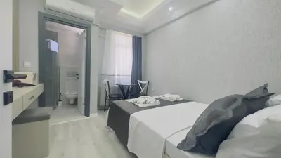 a hotel room with two beds and a bathroom at La Mer Old City Hotel in Istanbul