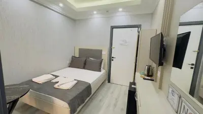 a small bedroom with a bed and a television at La Mer Old City Hotel in Istanbul