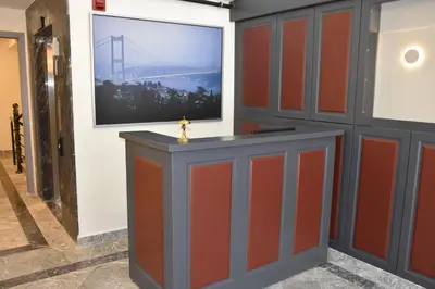 a room with orange and grey cabinets and a tv at Shishly Palace Hotel in Istanbul