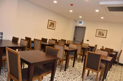 a classroom with tables and chairs and a chalkboard at Shishly Palace Hotel in Istanbul