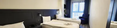 a hotel room with two beds and a window at Shishly Palace Hotel in Istanbul