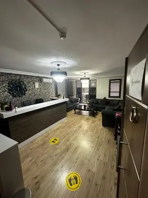 a living room with a couch and a kitchen at Overland Residence in Istanbul