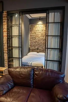 a bedroom with a bed and a couch in a room at Alness Residence in Istanbul