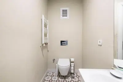 a white bathroom with a toilet and a sink at Homie Suites - Historical Apartments in the center of Beşiktaş in Istanbul