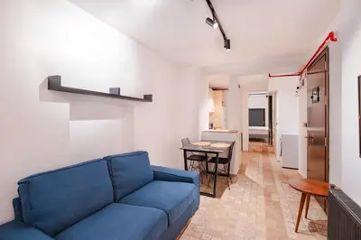 a living room with a blue couch and a table at Homie Suites - Modern Apartments Nearby Istıklal Street & Galata Tower in Istanbul