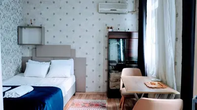 a small bedroom with a bed and a table at Stylish apartment in Istanbul