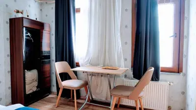 a room with a table and two chairs and a window at Stylish apartment in Istanbul