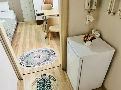 a small room with a refrigerator and a table at Stylish apartment in Istanbul