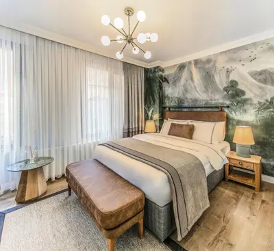 a bedroom with a large bed and a painting on the wall at CLK Suites Hotel in Istanbul