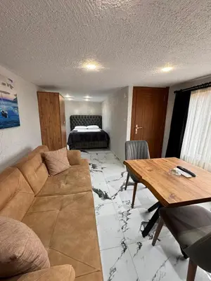 a living room with a couch and a table at İdeal Butik Otel in Arnavutköy