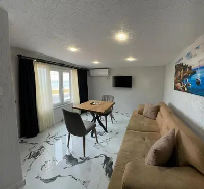 a living room with a couch and a table at İdeal Butik Otel in Arnavutköy