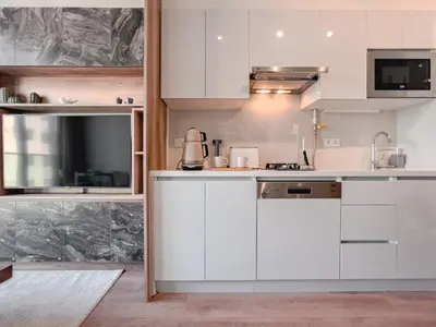 a kitchen with white cabinets and a sink at Homie Suites - Newly-constructed Apartment Complex in Beşiktaş in Istanbul