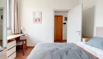 a white bedroom with a bed and a desk and a desk at Homie Suites - Newly-constructed Apartment Complex in Beşiktaş in Istanbul