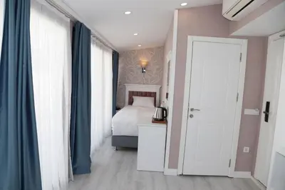 a bedroom with a bed and a white door at Novus Hotel İstanbul in Istanbul
