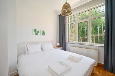 a bedroom with a white bed and a window at Cozy Cute 1 bed1bath Bebek Private Terrace! #75 in Istanbul