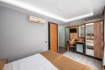 a bedroom with a bed and a desk in a room at Boutique Dedem Hotel Sultanahmet in Istanbul