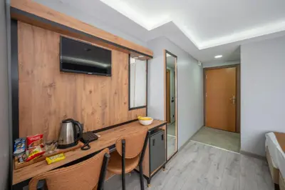 a room with a desk with a television on a wall at Boutique Dedem Hotel Sultanahmet in Istanbul