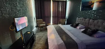 a hotel room with a bed and a television at İNCİ HOUSE in Kırac