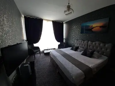 a hotel room with a bed and a large window at İNCİ HOUSE in Kırac