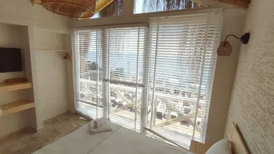 a room with a large window with a view of a barn at The Roof Ada in Adalar