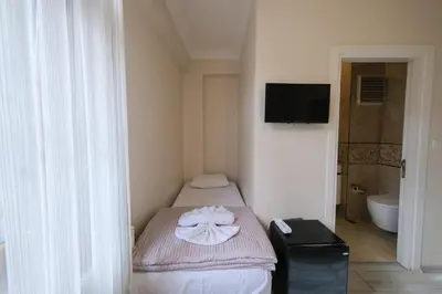 a small room with a bed with a towel on it at Halil Bey Konağı in Istanbul