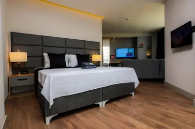 a bedroom with a large bed and a television at Brand Business Hotel in Corlu