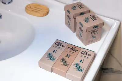 four brown boxes sitting on top of a white sink at Brand Business Hotel in Corlu