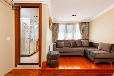 a living room with a couch and a window at Brown Mansion Oldcity in Istanbul