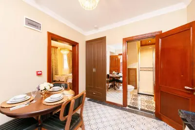 a dining room with a table and chairs and a room at Brown Mansion Oldcity in Istanbul