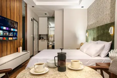 a hotel room with a bed and two cups on a table at La Mia Suites in Istanbul