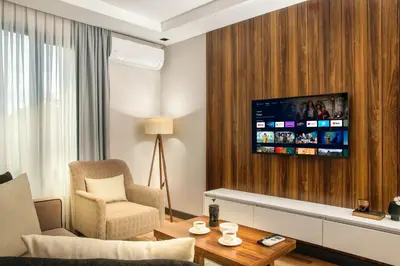 a living room with a television on a wall at La Mia Suites in Istanbul