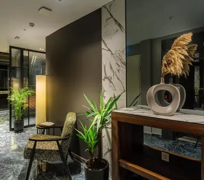 a living room with a fireplace and two chairs at La Mia Suites in Istanbul