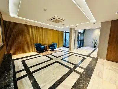 a lobby with chairs and a table in a building at Nice Royal Cıty in Istanbul