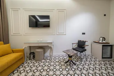 a living room with a couch and a table and a chair at Pera Luna Premium Hotel in Istanbul
