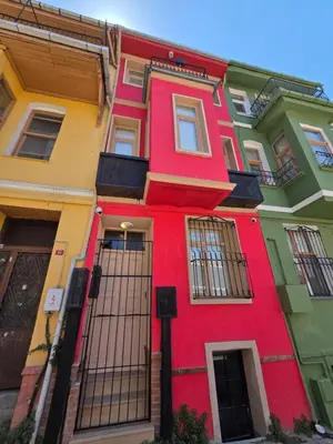 a brightly colored building in a city at Balat Historical House in Istanbul