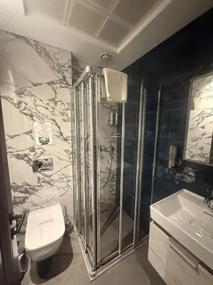 a bathroom with a shower and a toilet and a sink at Union Hotel Plat Inn -Special Category in Istanbul