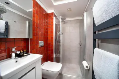 a bathroom with a shower and a toilet and a sink at Union Hotel Plat Inn -Special Category in Istanbul