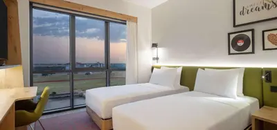 a hotel room with two beds and a window at Hampton By Hilton Cerkezkoy in Tekirdag