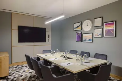 a conference room with a table and chairs and a tv at Hampton By Hilton Cerkezkoy in Tekirdag