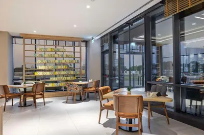 a restaurant with tables and chairs and windows at Hampton By Hilton Cerkezkoy in Tekirdag